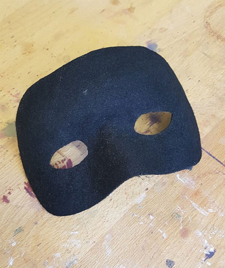 The set felt mask trimmed to the shape of a Zorro mask 