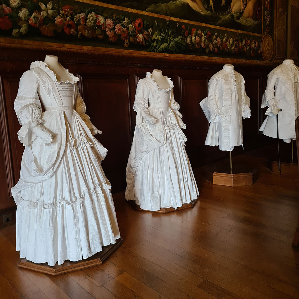 The paper costumes in their palace setting